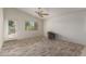 Bright living room with wood-look tile floors, ceiling fan, and access to the backyard at 727 W Judi Dr, Casa Grande, AZ 85122