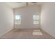 Bright bedroom featuring two large windows and carpet at 727 W Judi Dr, Casa Grande, AZ 85122