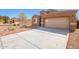 Tan one story home with a two-car garage and desert landscaping at 727 W Judi Dr, Casa Grande, AZ 85122
