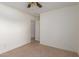 Simple bedroom with ceiling fan and door to bathroom at 727 W Judi Dr, Casa Grande, AZ 85122