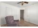 Bedroom with armchair, ceiling fan and double doors at 727 W Judi Dr, Casa Grande, AZ 85122
