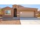 Tan one-story home with a two-car garage at 727 W Judi Dr, Casa Grande, AZ 85122