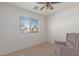 Cozy bedroom with a window, ceiling fan and armchair at 727 W Judi Dr, Casa Grande, AZ 85122