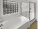 Bathroom with soaking tub, shower, and a window at 11575 W Buchanan St, Avondale, AZ 85323