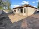 Large backyard with dirt and partial home view at 11575 W Buchanan St, Avondale, AZ 85323