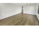 Bright living room with wood-look floors and a ceiling fan at 11575 W Buchanan St, Avondale, AZ 85323