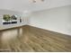Open living room with wood-look floors and natural light at 11575 W Buchanan St, Avondale, AZ 85323