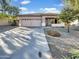 Single-story home with a two-car garage and landscaping at 11575 W Buchanan St, Avondale, AZ 85323