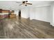 Open concept living room with hardwood floors and kitchen view at 11575 W Buchanan St, Avondale, AZ 85323