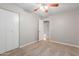 Carpeted bedroom with double door closet and ceiling fan at 2114 S El Marino --, Mesa, AZ 85202