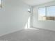 Bright bedroom with grey carpet and large windows at 16173 S 181St Ave, Goodyear, AZ 85338