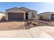 Single-story home with a two-car garage and landscaped front yard at 16173 S 181St Ave, Goodyear, AZ 85338