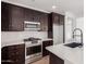 Modern kitchen features dark cabinetry, stainless steel appliances, and white quartz countertops at 16173 S 181St Ave, Goodyear, AZ 85338