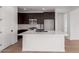 Spacious kitchen with dark cabinetry, stainless steel appliances and island at 16173 S 181St Ave, Goodyear, AZ 85338