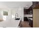 Modern kitchen with white quartz countertops and dark cabinets at 16173 S 181St Ave, Goodyear, AZ 85338