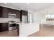 Modern kitchen with island, stainless steel appliances and white quartz countertops at 16173 S 181St Ave, Goodyear, AZ 85338