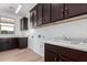 Laundry room with dark wood cabinets and a built in utility sink at 16173 S 181St Ave, Goodyear, AZ 85338