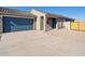 Front exterior of a house with blue garage and driveway at 2688 E San Miguel Dr, Casa Grande, AZ 85194