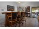 Wet bar with seating for three, located off living room at 9856 W Rimrock Dr, Peoria, AZ 85382