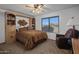 Cozy bedroom with built-in shelves and a relaxing chair at 9856 W Rimrock Dr, Peoria, AZ 85382