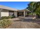 View of house exterior showcasing a covered patio and landscaping at 9856 W Rimrock Dr, Peoria, AZ 85382