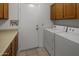 Functional laundry room with washer, dryer, and storage at 9856 W Rimrock Dr, Peoria, AZ 85382