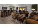 Spacious living room with comfortable seating and a wet bar at 9856 W Rimrock Dr, Peoria, AZ 85382