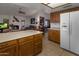 Kitchen with island, white refrigerator, and wood cabinets at 9856 W Rimrock Dr, Peoria, AZ 85382