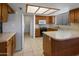 Galley kitchen with wood cabinets and island at 9856 W Rimrock Dr, Peoria, AZ 85382