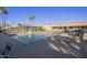 Community pool area with lounge chairs, tables, and a shaded seating area at 9856 W Rimrock Dr, Peoria, AZ 85382