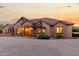 Elegant home exterior with stone and tile, warm lighting at 2336 E Elk Bugle Trl, San Tan Valley, AZ 85140