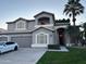 Two-story house with a three-car garage and palm trees at 760 N Ithica St, Gilbert, AZ 85233