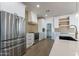 Modern kitchen with white cabinets, stainless steel appliances, and a large island at 3909 S Veronica Ln, Gold Canyon, AZ 85118