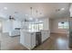 Open concept kitchen island with white cabinets and stainless steel appliances at 3909 S Veronica Ln, Gold Canyon, AZ 85118