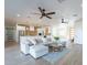 Open floorplan with kitchen and living area, featuring a sectional sofa and large windows at 3909 S Veronica Ln, Gold Canyon, AZ 85118