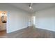 Bright bedroom with wood-look floors and access to bathroom and hallway at 3909 S Veronica Ln, Gold Canyon, AZ 85118