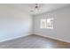 Simple bedroom with wood-look floors, ceiling fan and window at 3909 S Veronica Ln, Gold Canyon, AZ 85118