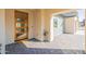 Modern front entry with a wooden door and tile flooring at 3909 S Veronica Ln, Gold Canyon, AZ 85118