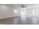 Bright bedroom with wood-look floors, ceiling fan, and multiple windows at 3909 S Veronica Ln, Gold Canyon, AZ 85118
