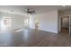 Spacious bedroom with wood-look floors, ceiling fan, and access to bathroom at 3909 S Veronica Ln, Gold Canyon, AZ 85118
