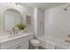 Updated bathroom with white vanity, chevron tile shower, and gold fixtures at 19700 N 76Th St # 1116, Scottsdale, AZ 85255