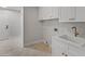 Modern laundry room with white cabinets and gold faucet at 19700 N 76Th St # 1116, Scottsdale, AZ 85255