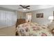 Bright bedroom with floral bedding, ceiling fan and a dresser at 7285 E Arlington Rd, Scottsdale, AZ 85250