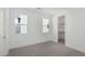 Bright bedroom with plush carpeting, double windows, and a spacious walk-in closet at 10223 E Ulysses Ave, Mesa, AZ 85212