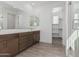 Double vanity bathroom with a walk-in shower and access to a closet at 10223 E Ulysses Ave, Mesa, AZ 85212