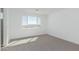 Bedroom with large window, en-suite bathroom, and carpet flooring at 10223 E Ulysses Ave, Mesa, AZ 85212