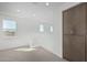 Spacious loft area with large windows, built-in cabinets, and carpeted flooring at 10223 E Ulysses Ave, Mesa, AZ 85212