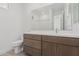 Modern bathroom with wood vanity, large mirror, and a shower/tub combo at 10223 E Ulysses Ave, Mesa, AZ 85212