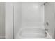 Simple bathroom with white tile and bathtub at 4321 N 50Th Dr, Phoenix, AZ 85031