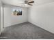 Bright bedroom featuring a ceiling fan and large window at 4321 N 50Th Dr, Phoenix, AZ 85031